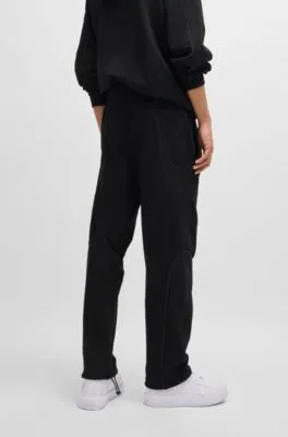 Cotton-terry tracksuit bottoms with decorative reflective trims