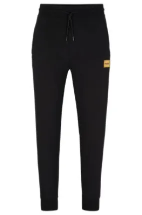 Cotton-terry tracksuit bottoms with foil-print logo