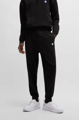 Cotton-terry tracksuit bottoms with Happy HUGO logo patch