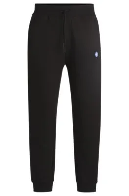 Cotton-terry tracksuit bottoms with Happy HUGO logo patch