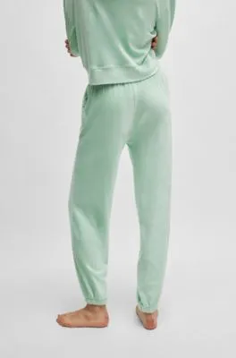 Cuffed tracksuit bottoms in terry fabric with handwritten logo